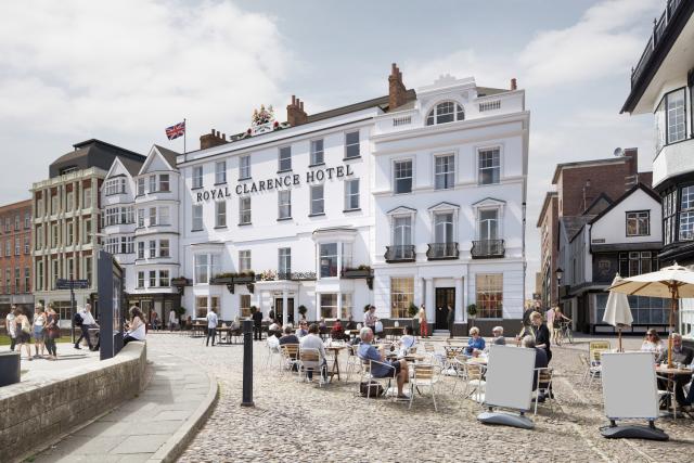 a cgi of the historic royal clarence hotel, rendered in white with a pavement cafe in the foreground