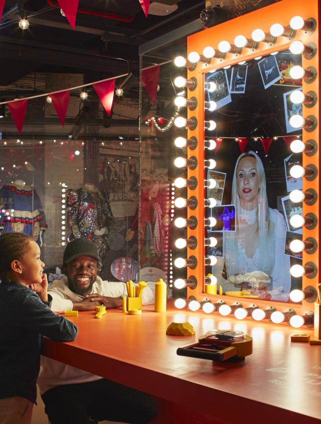 A child looks into an interactive mirror display at Showtown, Blackpool