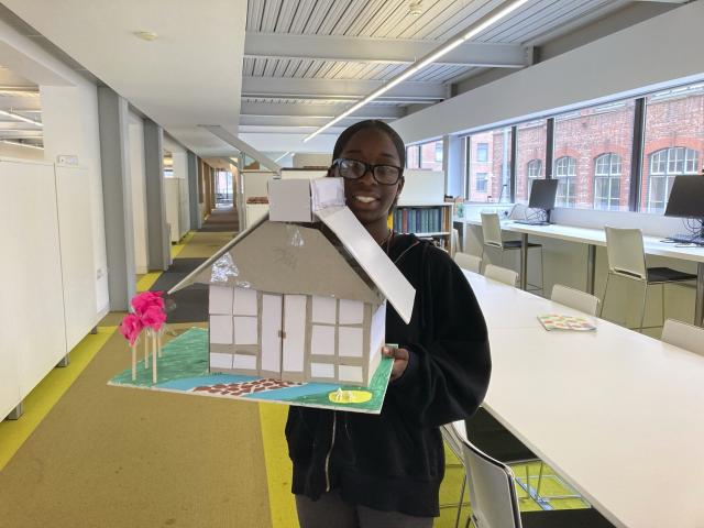 a student is showing us the model of her house made during her work experience in the buttress studio