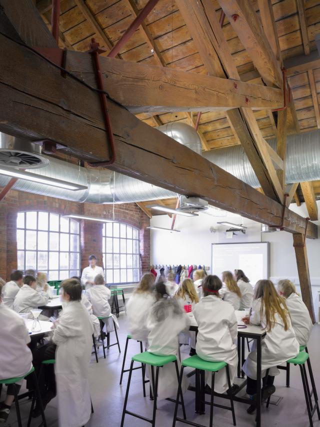 children in white coats in the education rooms at MOSI