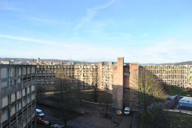 a view across the park hill housing estate with the city skyline behind