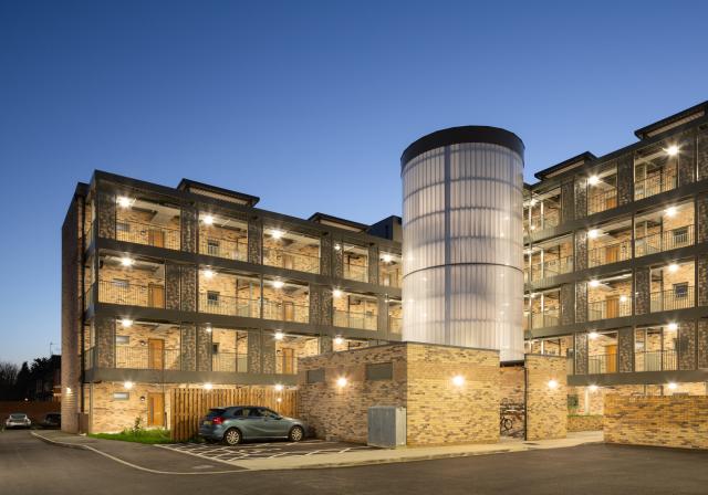 A brightly illuminated building against a dark night sky.