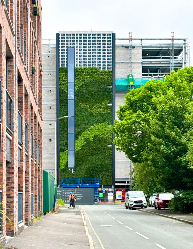 the green wall of the ancoats mobility hub being constructed