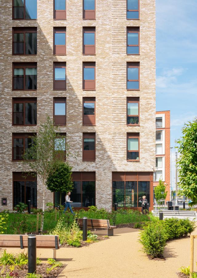 a small pocket park leads to the door of 'greenhaus' passivhaus apartments in Salford.