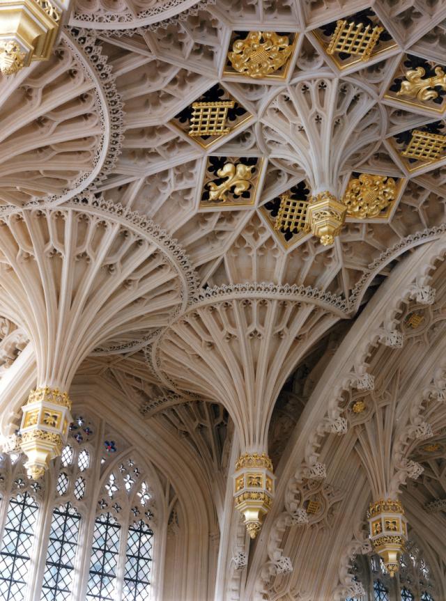 Interior ceiling of Westminster Abbey, showing an ornate gold and white fan-vaulting on the ceiling.