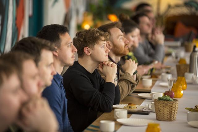 Group photo of people sitting down a table