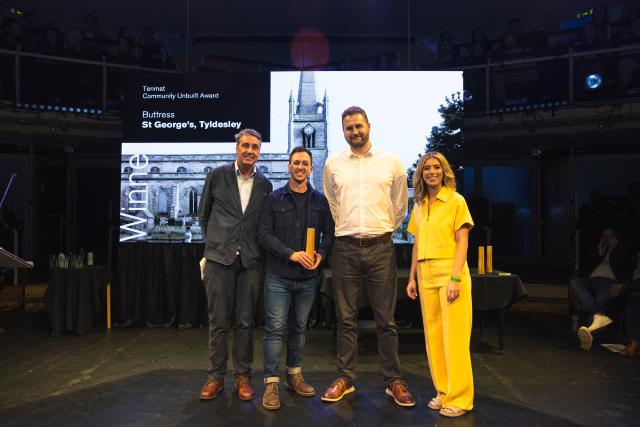 Four people stanidng on a stage