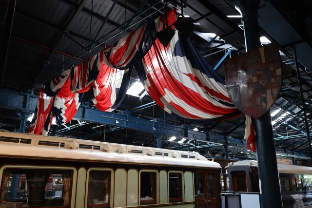A historic train carriage under Union Jack flags