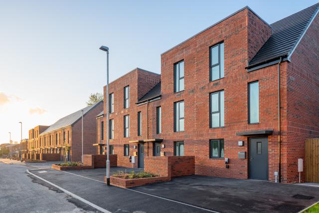 Red brick two storey houses facing onto a street