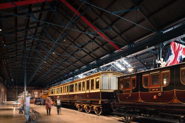 A wide view of people exploring the exhibits inside the station hall.